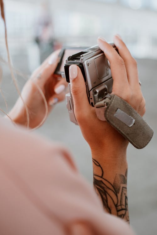 Free Person Holding A Silver Camera Stock Photo