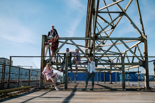 People Hanging Out on The Base of a Steel Tower