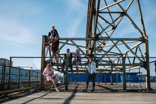 Free A group of friends hanging out on a rooftop structure on a sunny day. Stock Photo