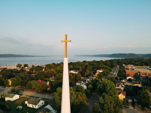Free Church Spire with Cross with Sea in Background Stock Photo