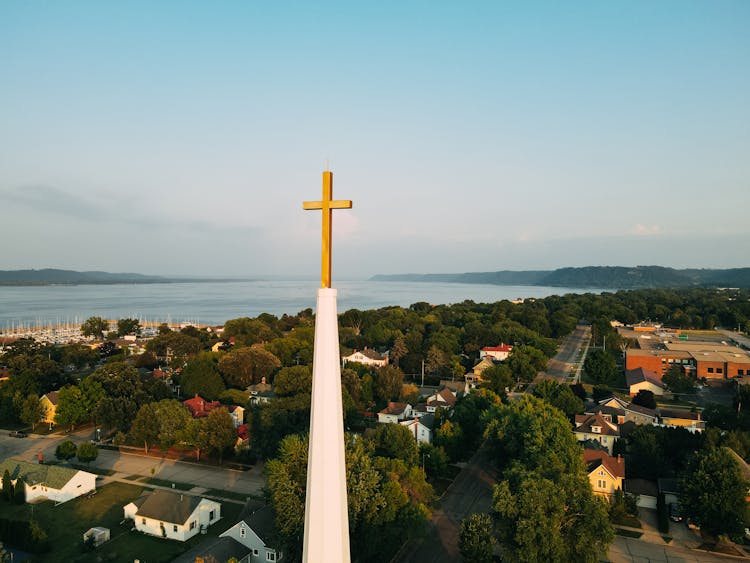 Church Spire With Cross With Sea In Background