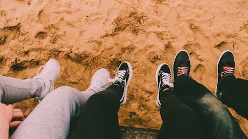 High-Angle Shot of Three People Wearing Rubber Shoes