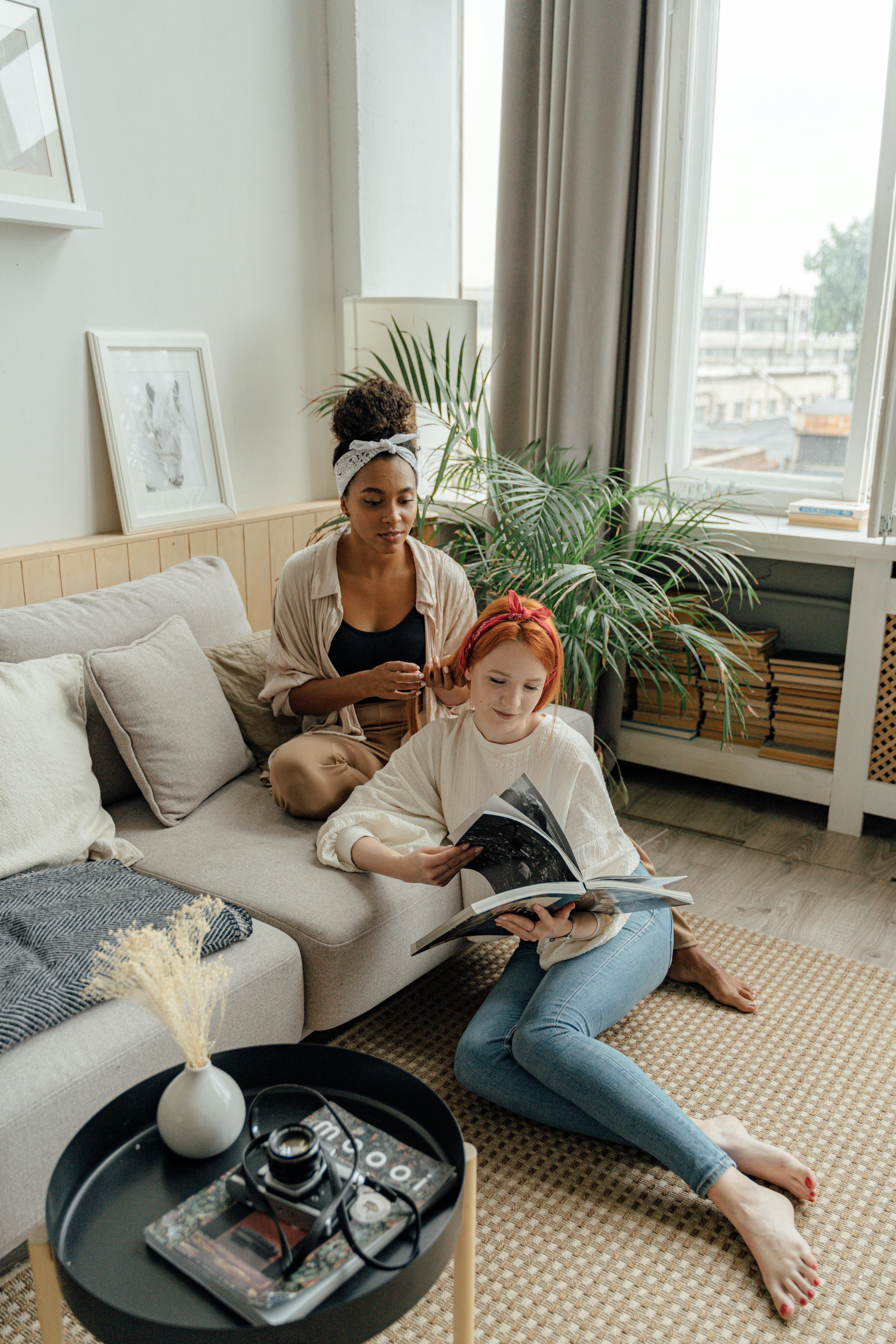 woman in brown long sleeve shirt sitting on white couch