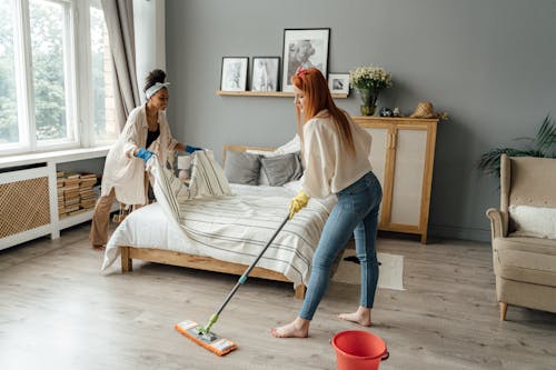 Free Women Cleaning a Bedroom Stock Photo