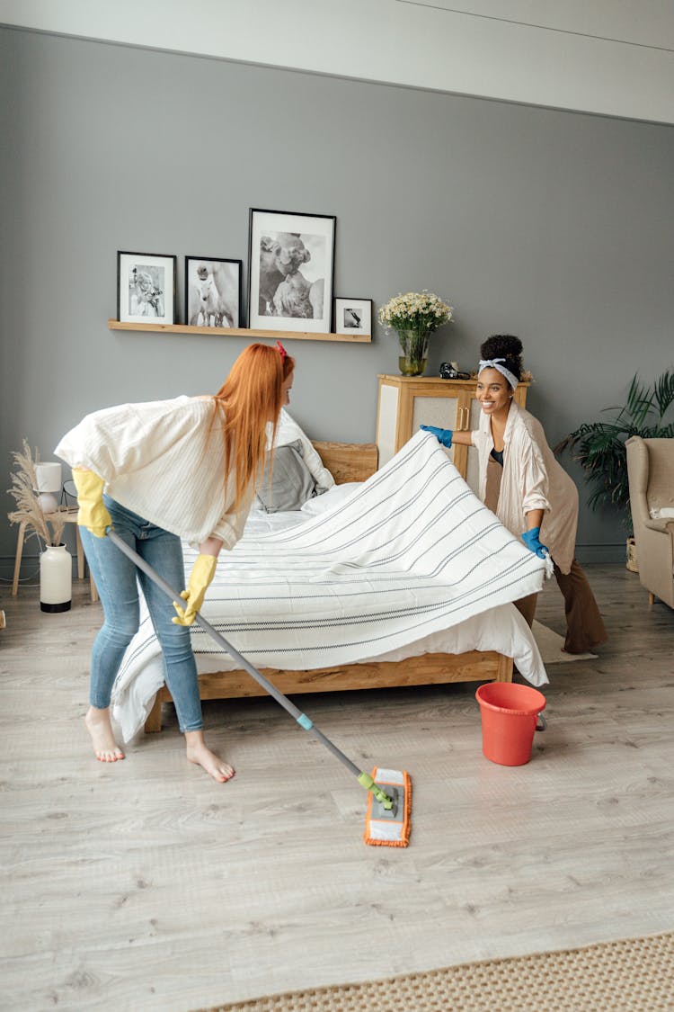 Women Cleaning The Bedroom Together