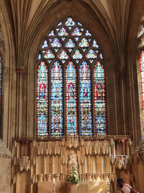 Free Cathedral Interior With Blue Red and Yellow Glass Windows Stock Photo