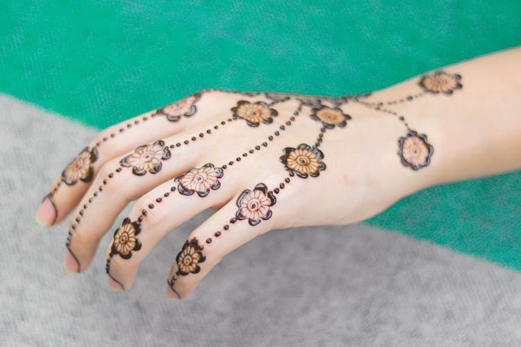 Floral Design Henna Skin Dye On A Woman's Hand