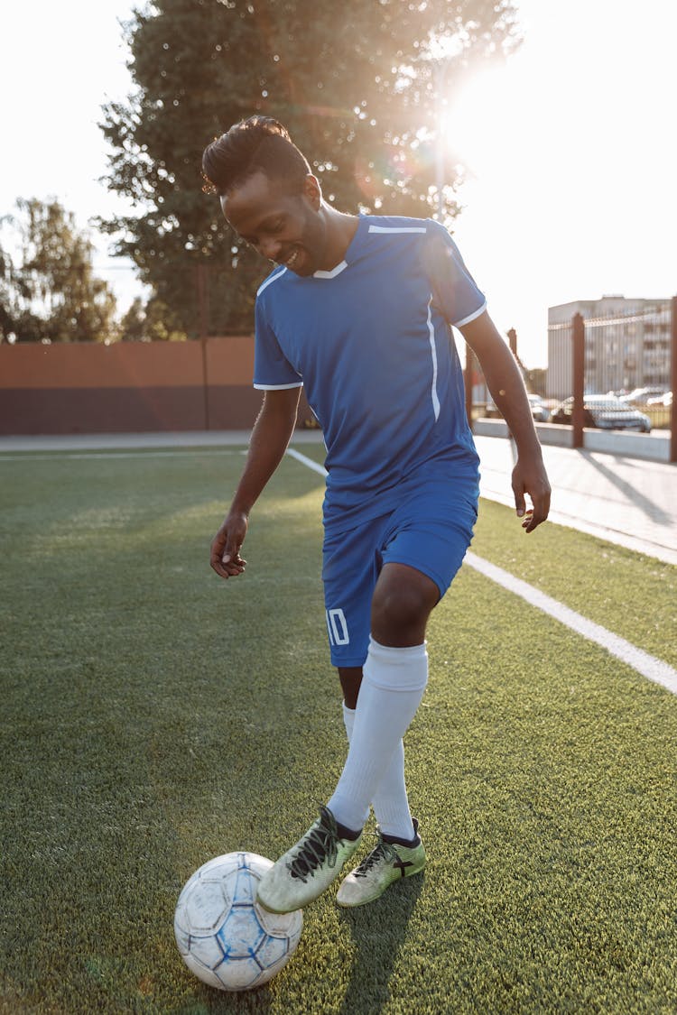 Man In Blue Soccer Jersey Playing Football 