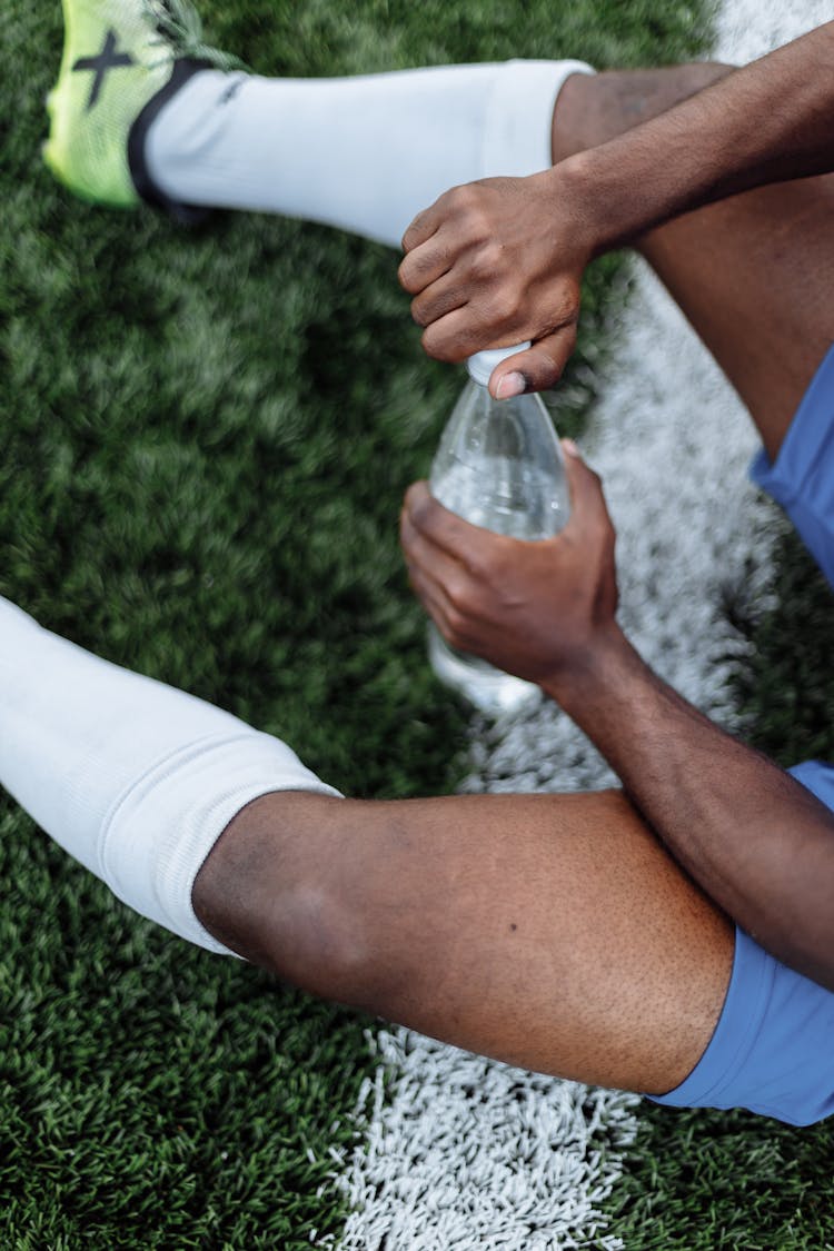 A Person Opening A Bottled Water