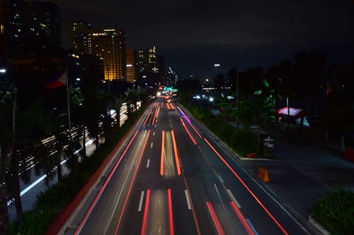 Traffic in modern illuminated city at night
