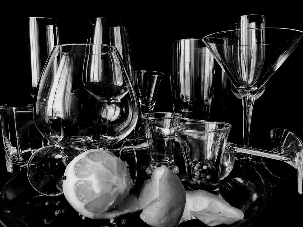 Free Collection of cocktail glassware placed on table with lemon Stock Photo