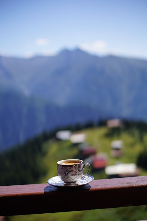 Cup of Coffee on the Railing of Balcony 