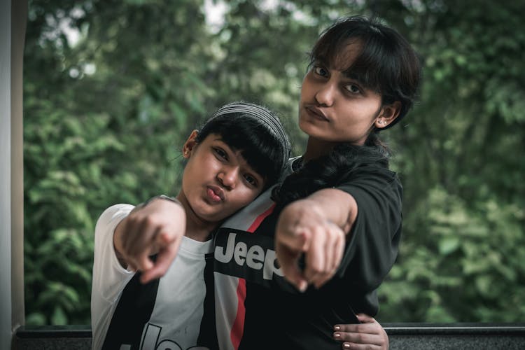 Portrait Of Girls Pointing At Screen