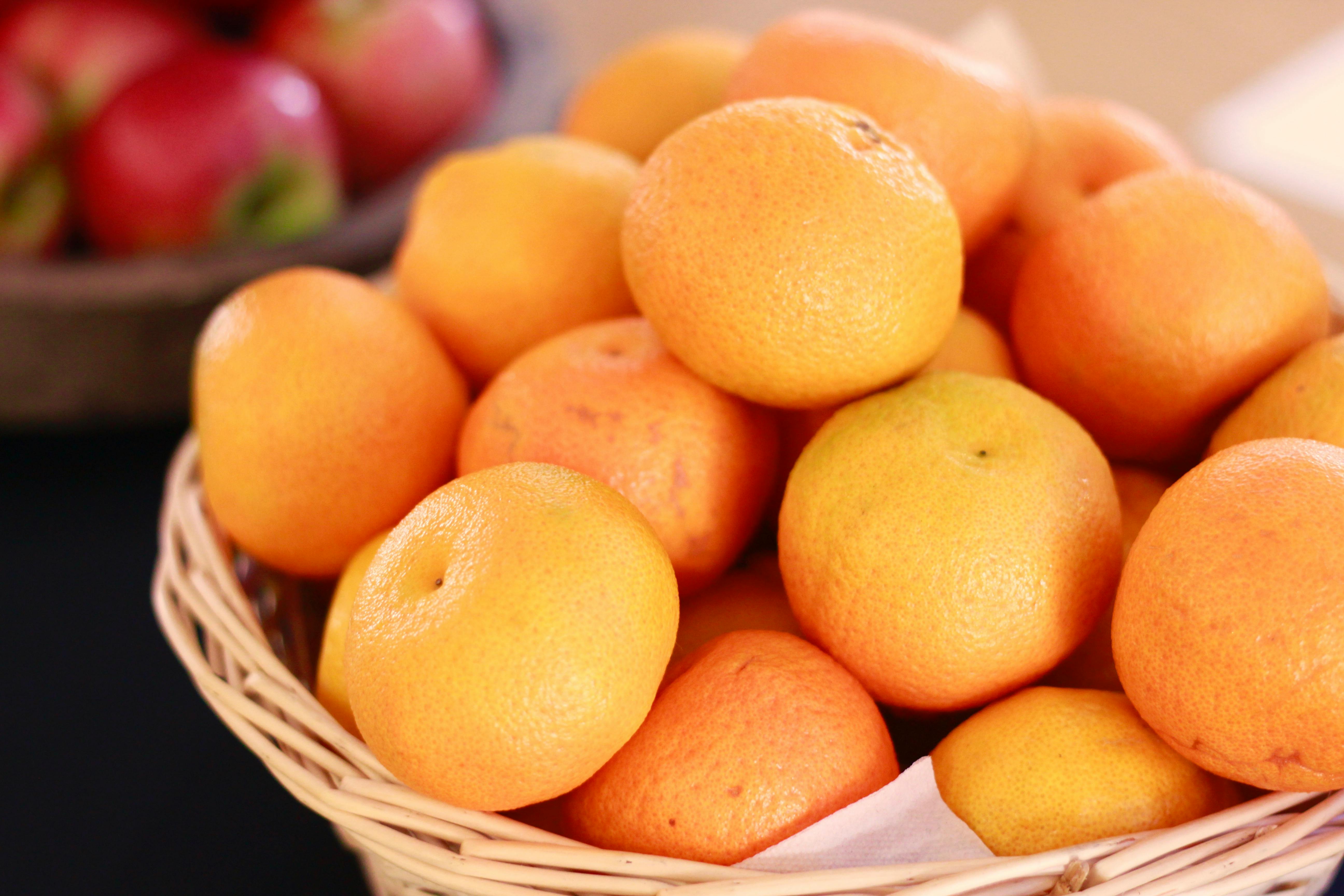 orange fruits on brown woven basket