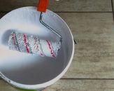 Pail of White Paint and Paint Roller