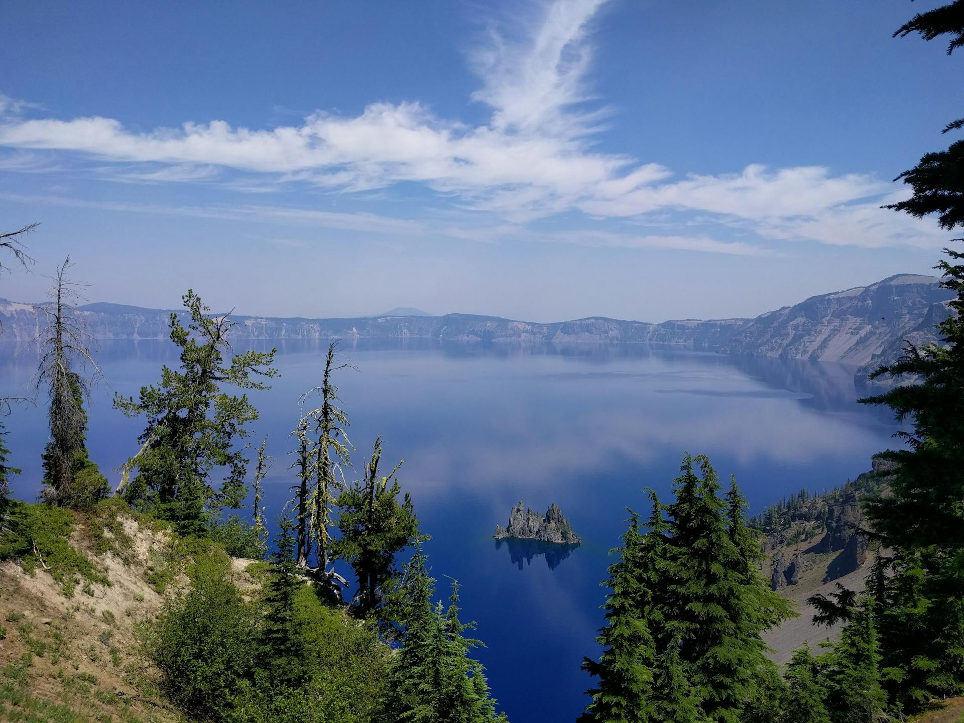 Beautiful view of Crater Lake National Park with clear blue waters and surrounding landscape.