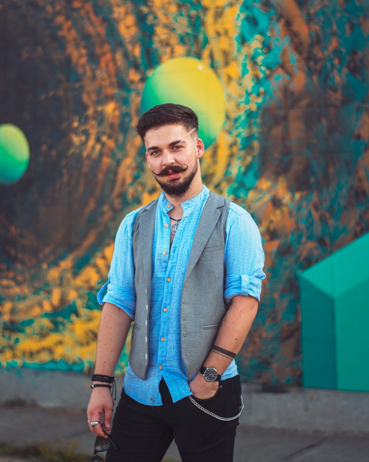 Portrait Of Man With Colorful Mural Behind