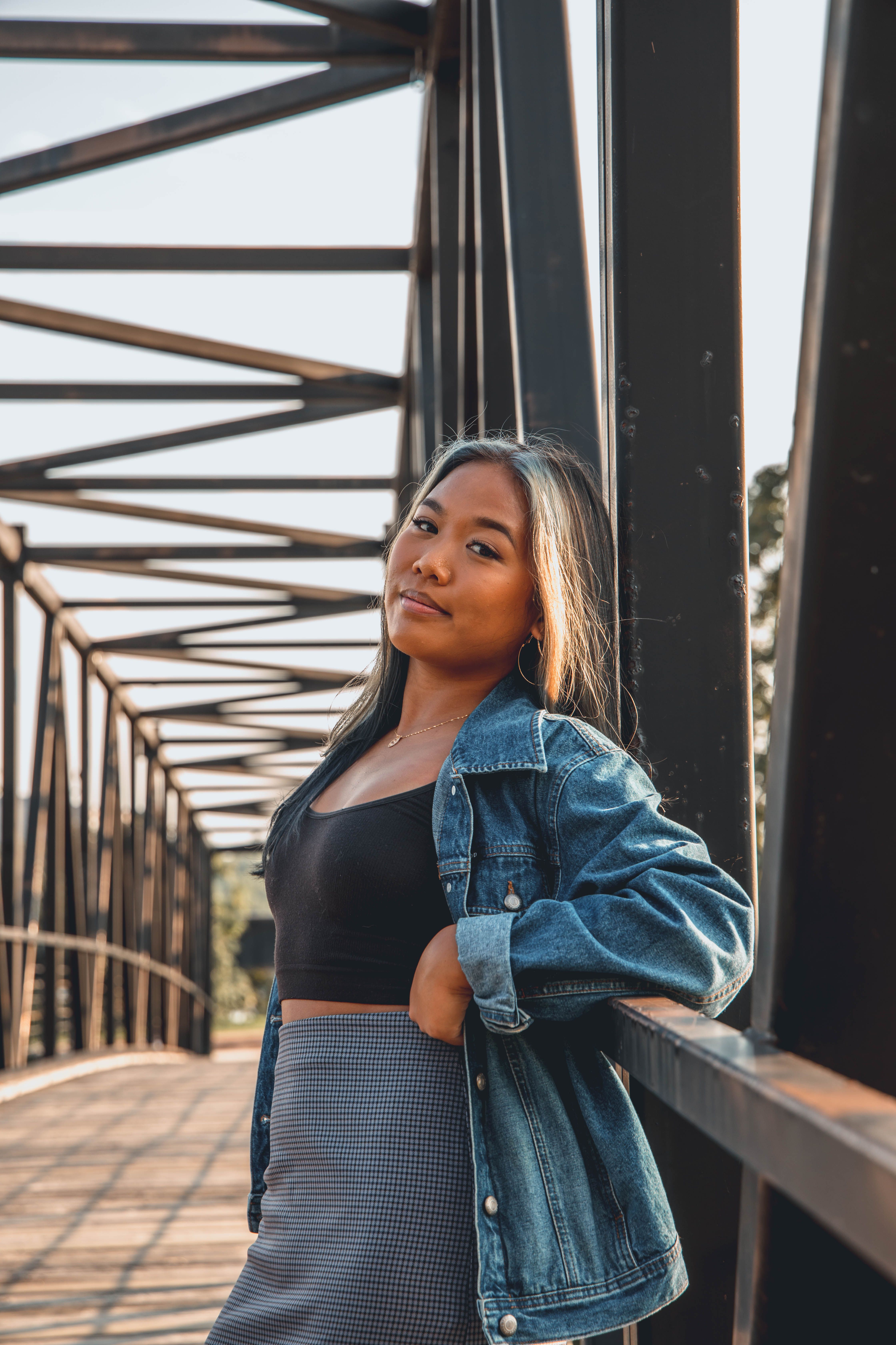 Stylish Young Woman Posing on Modern Bridge · Free Stock Photo