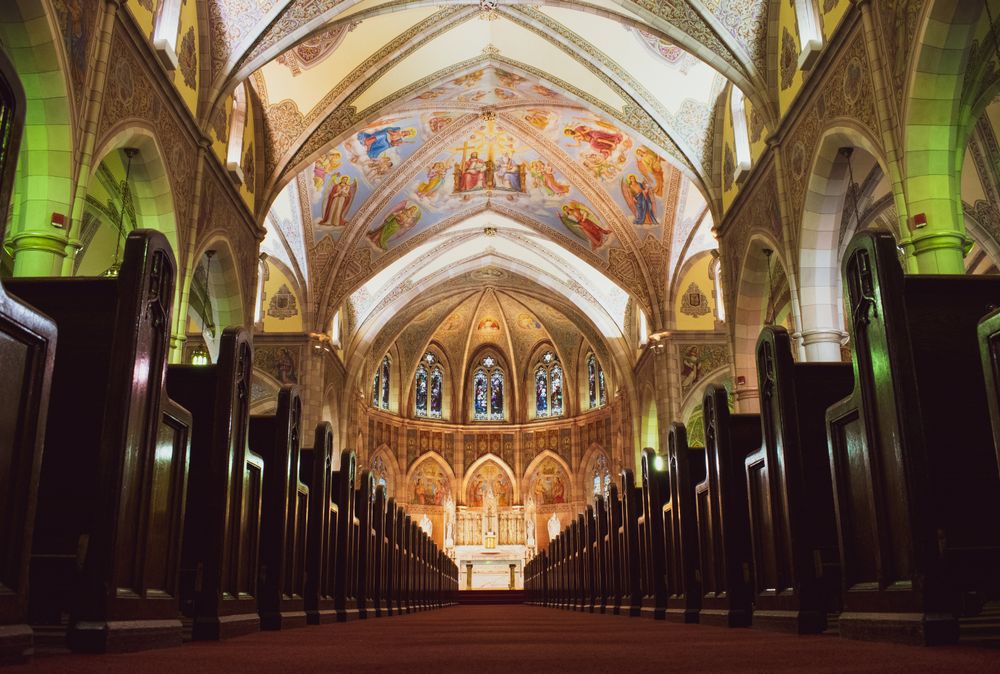 Historic church interior with stone arches and altar