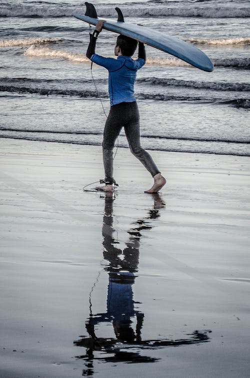 Boy Holding Blue Surfing Board