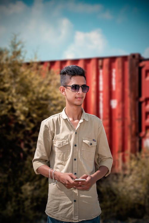 Man in Brown Button Up Shirt Wearing Black Sunglasses