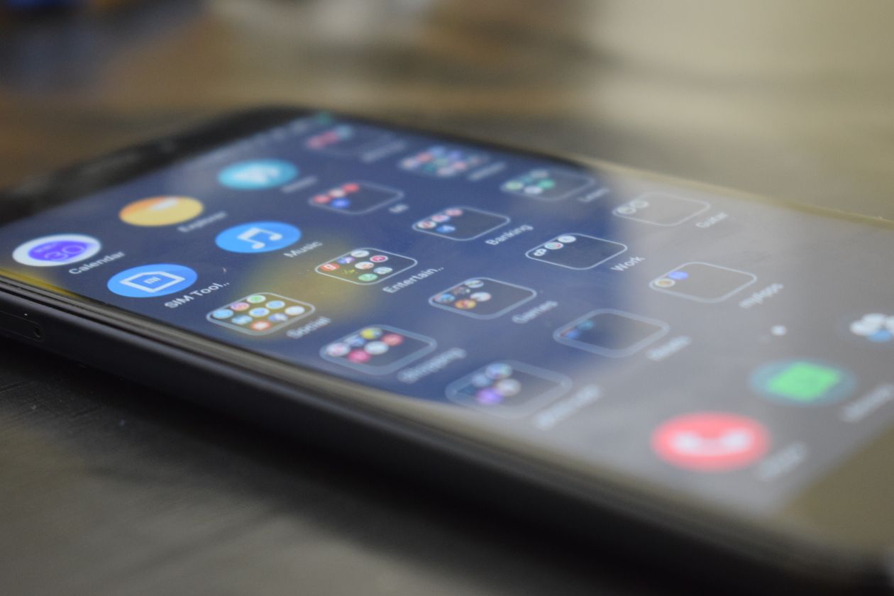 Close-up of a smartphone screen showing simple app icons, representing AI side hustles without a steep learning curve
