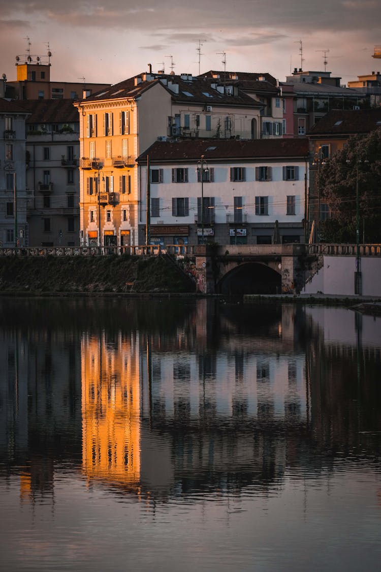 Aged Residential Buildings On Reflecting In Water Of Canal