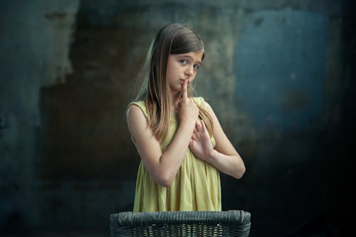 Free A Girl Doing a Shushing Finger Gesture Stock Photo