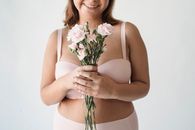 Woman in White Brassiere Holding White Flowers