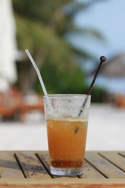 A Beverage with a Straw and Stirrer