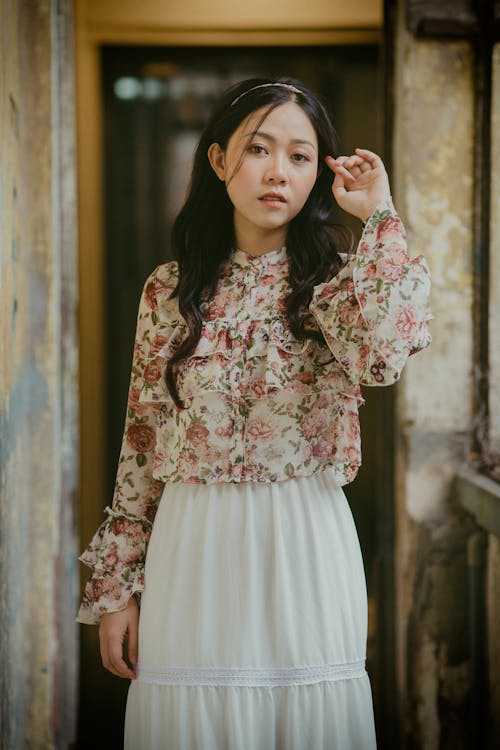 Stylish Asian woman in old house with shabby walls