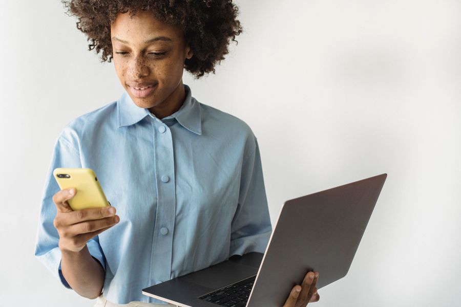 Young African professional working with a laptop and phone