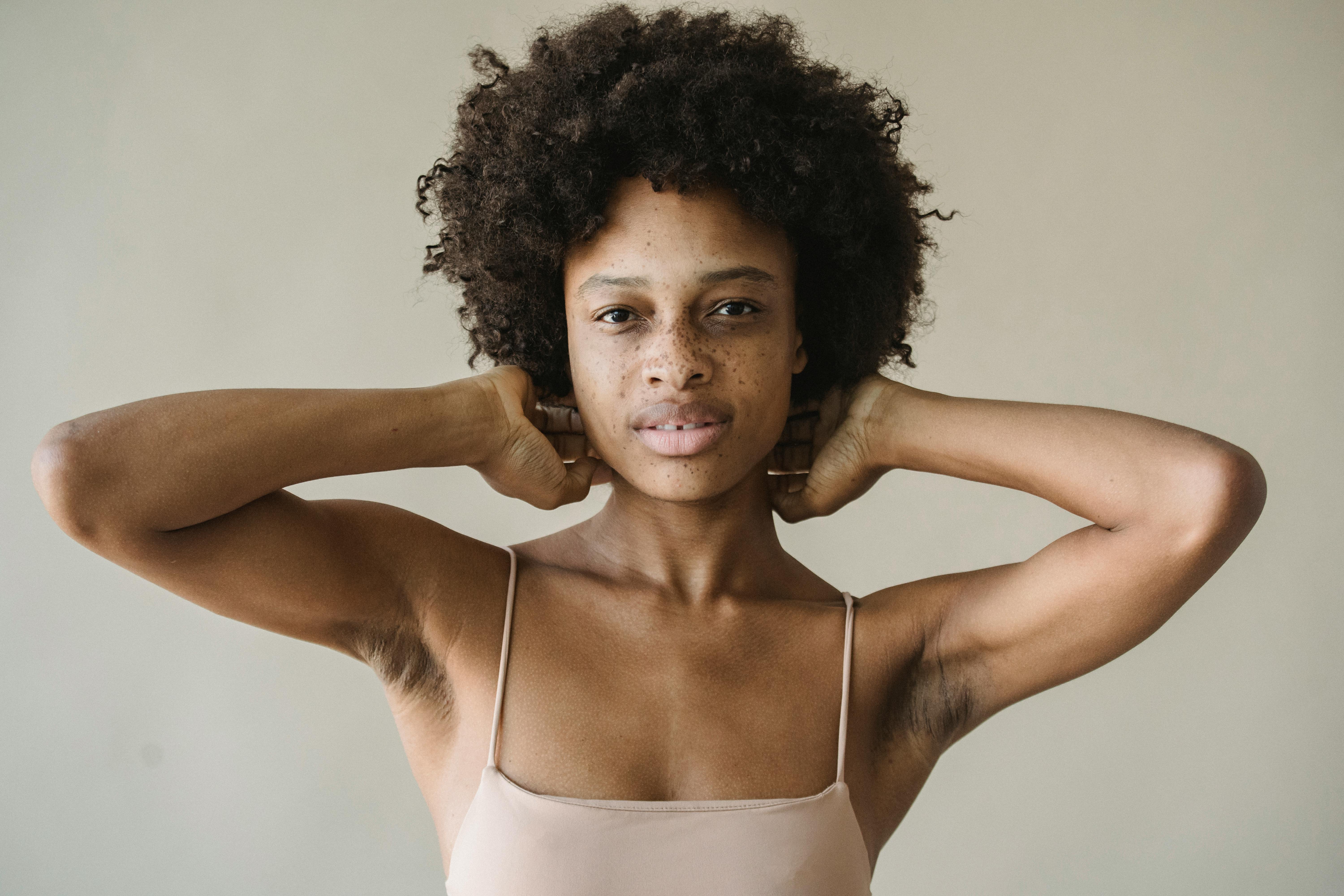 a woman in beige spaghetti strap top