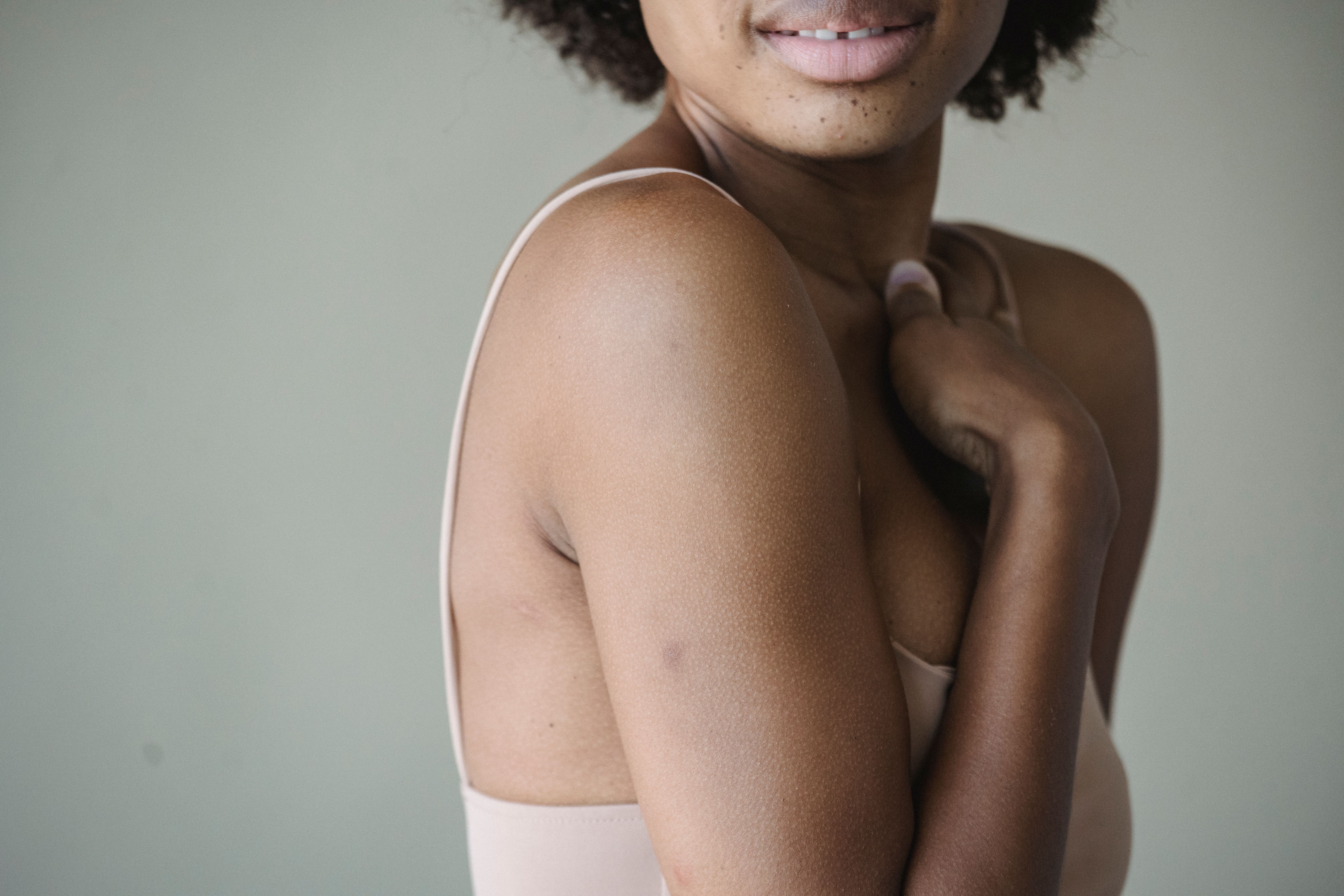 Intimate portrait of a woman showcasing natural skin texture and soft lighting.