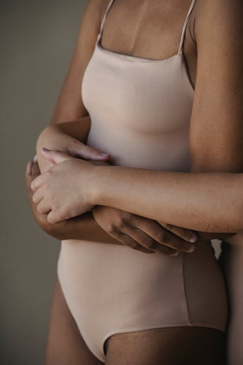 Mid Section of Woman in Beige Body Suit