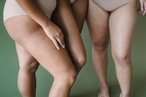 Bare Legs of Women in Skin Tone Underwear