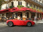 Red Convertible Car Parked Beside Pink Building