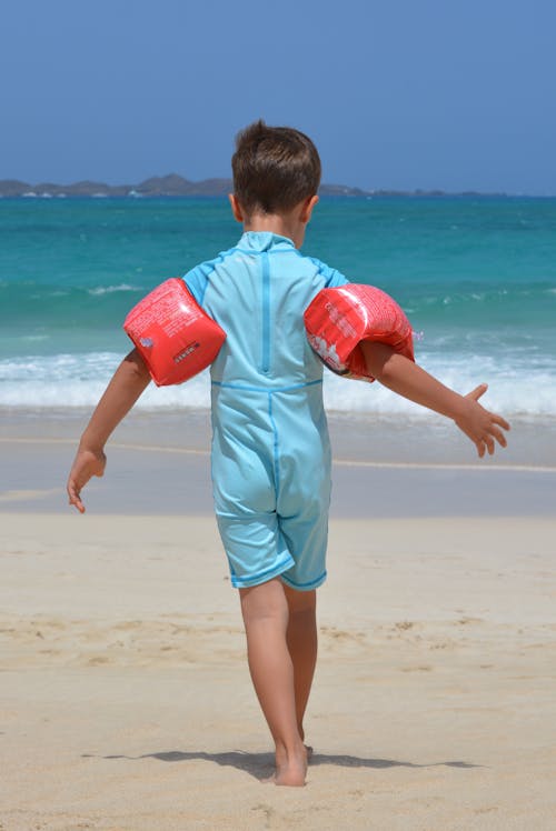 Boy on Blue Onesie on Beach during Day