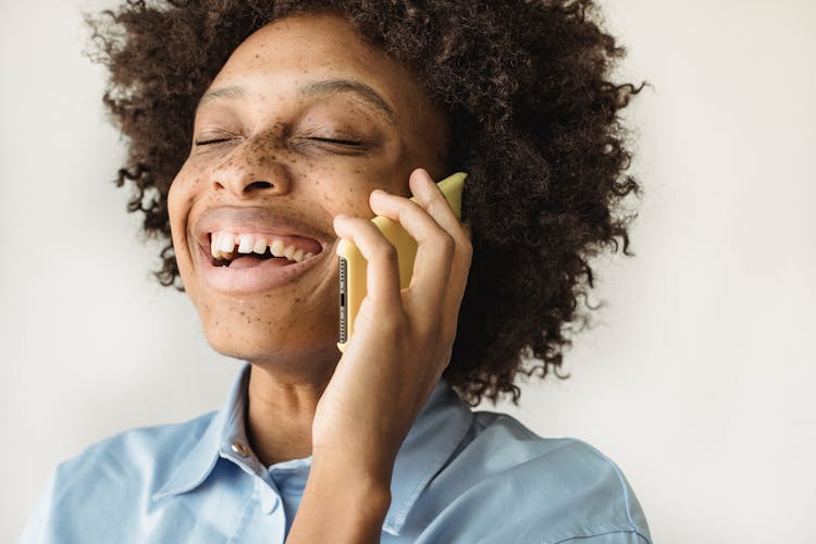 Close Up Of Woman With Afro Hairstyle Using Phone