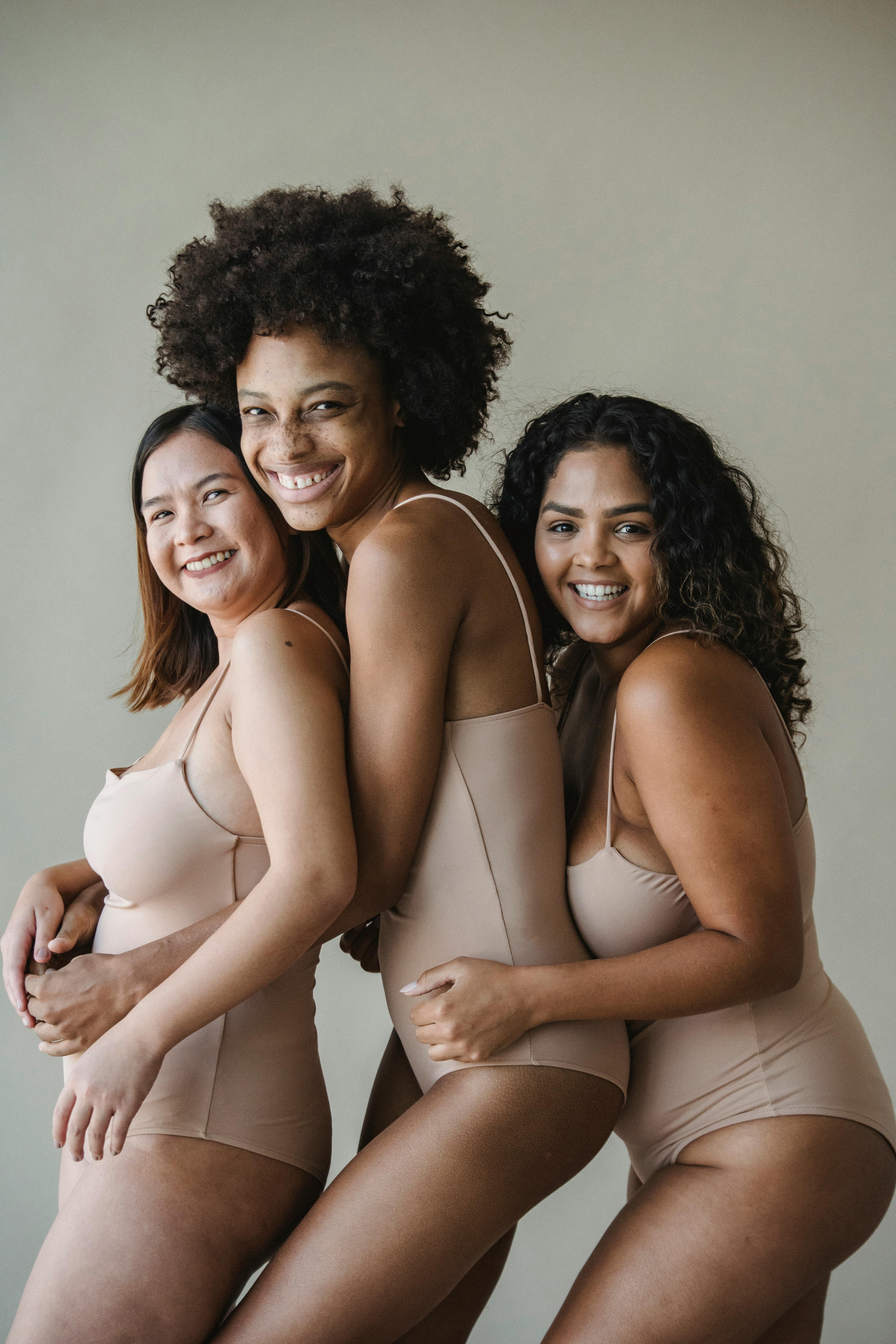 Women Posing in Nude Bodysuits Smiling · Free Stock Photo
