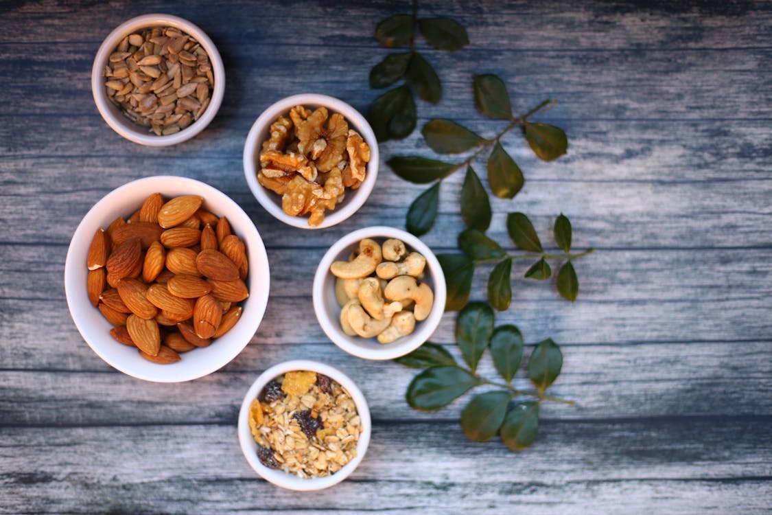 Free Assorted Nuts in White Ceramic Bowls Stock Photo