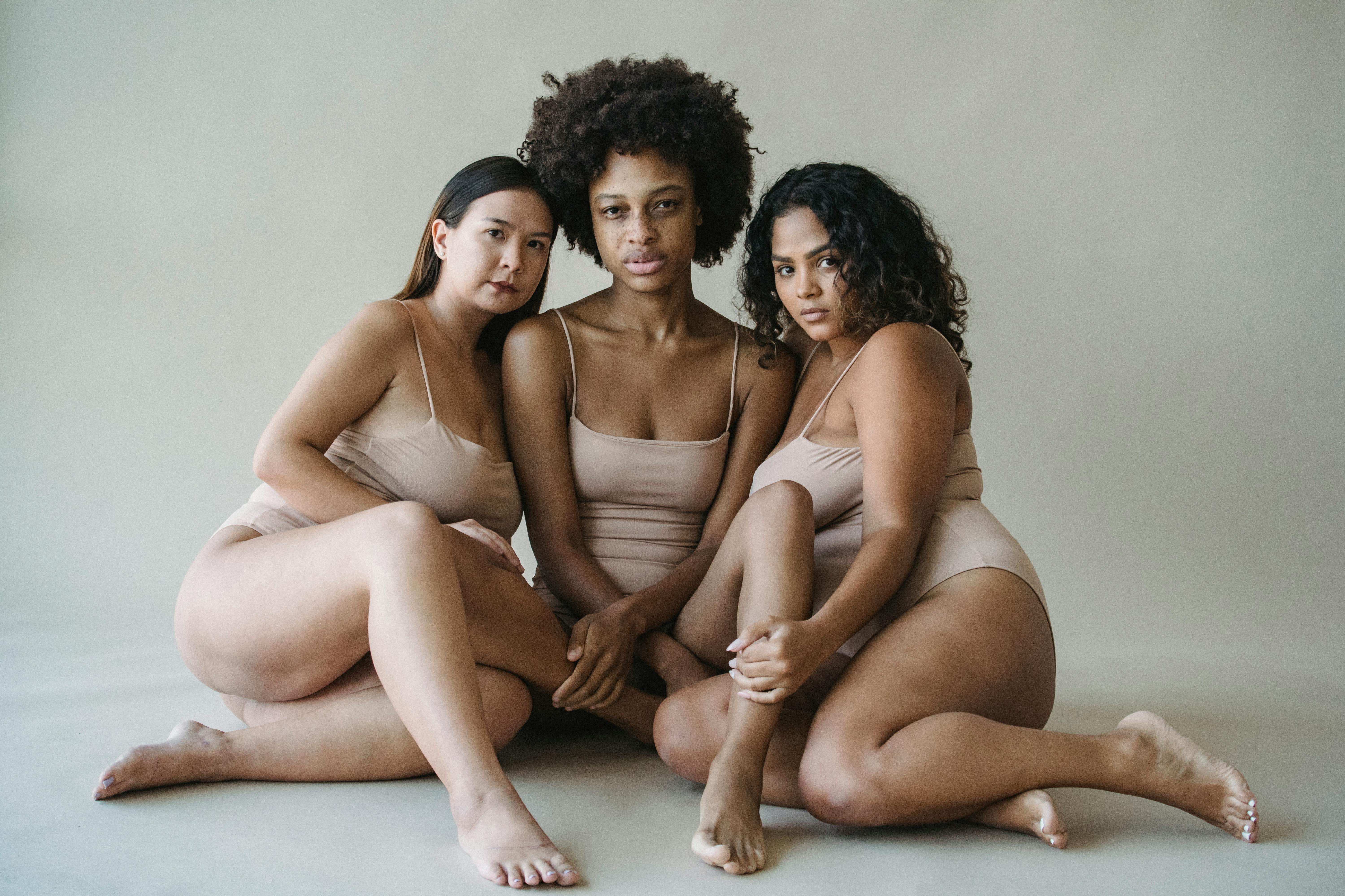 Three Young Women in Underwear Sitting Together on Floor · Free Stock Photo