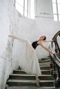 Woman in White Wedding Gown Standing on Stairs