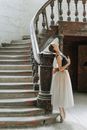 Woman in White Wedding Dress Standing on Staircase