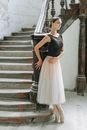 Woman in Black and White Dress Standing on Gray Concrete Staircase