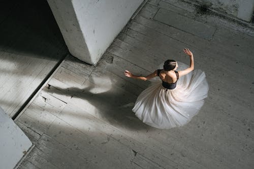 A Woman in White Skirt Dancing Ballet