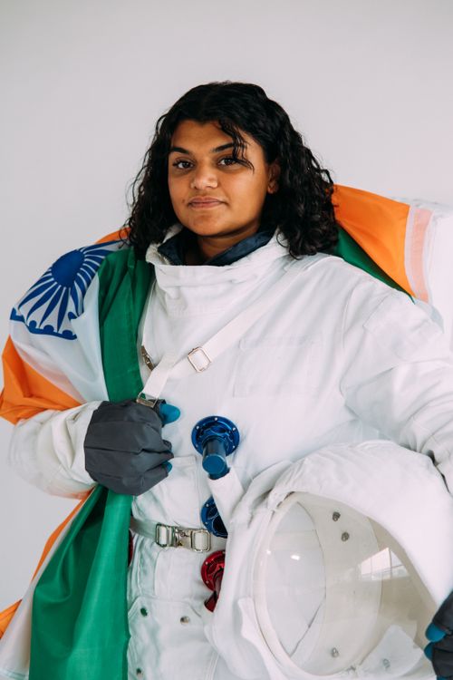 Free A woman in a space suit wearing the Indian flag, representing space exploration. Stock Photo