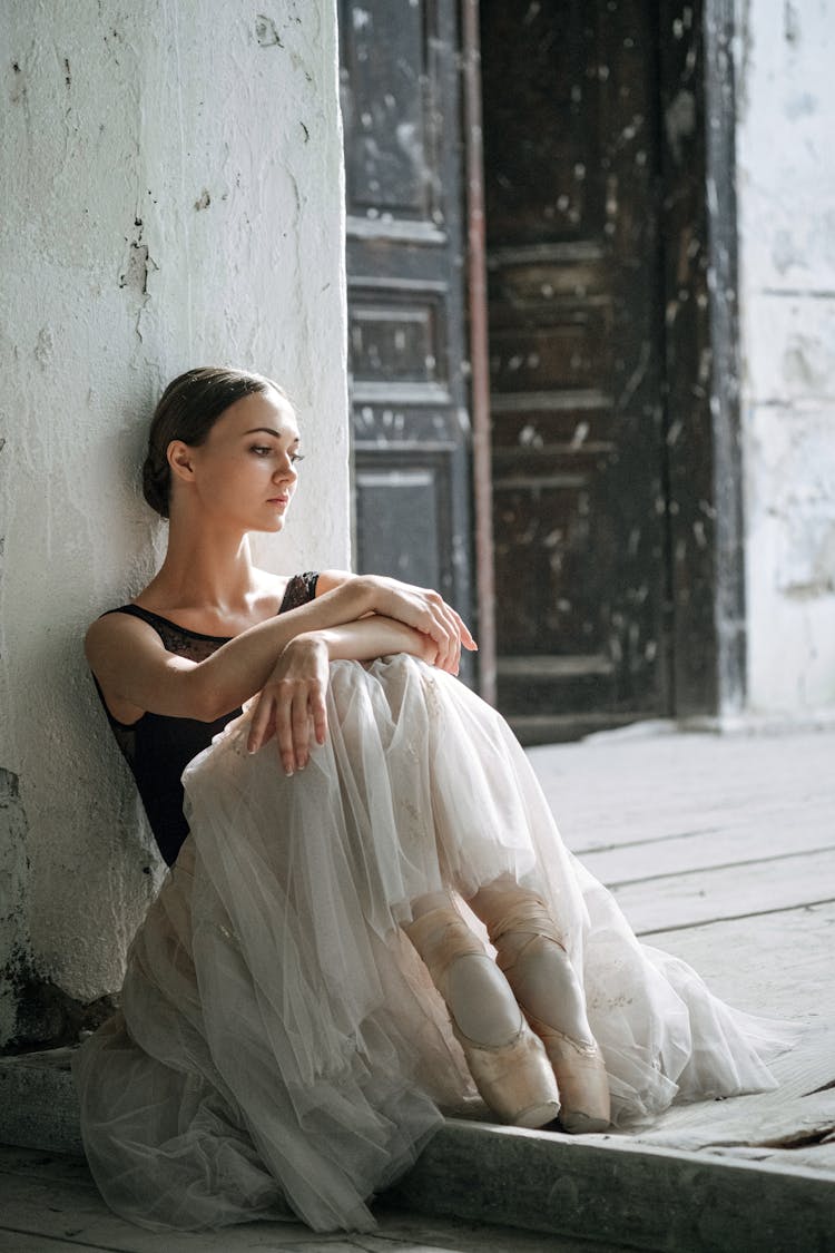 A Ballerina Sitting On The Floor 