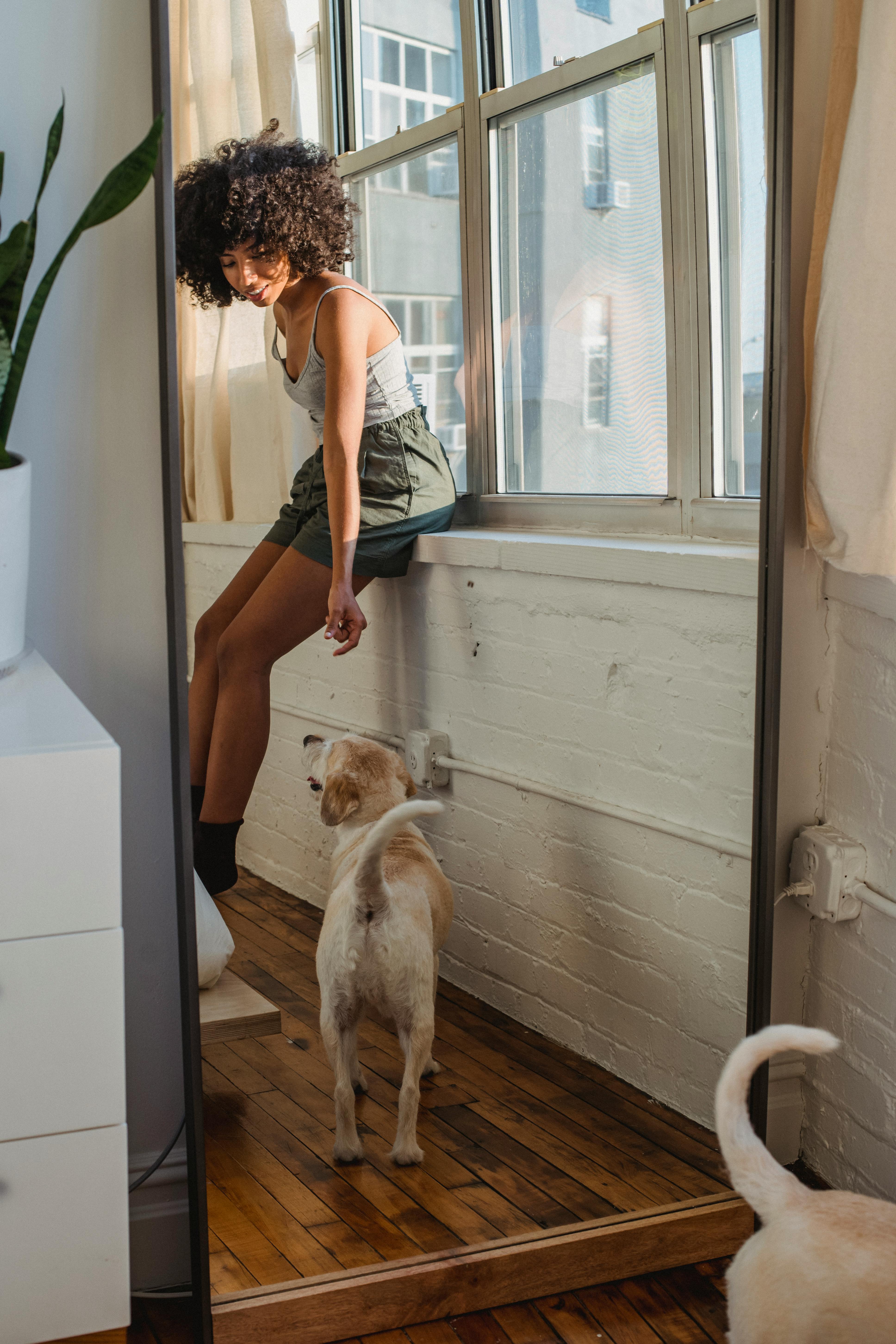 Reflection of black woman with dog
