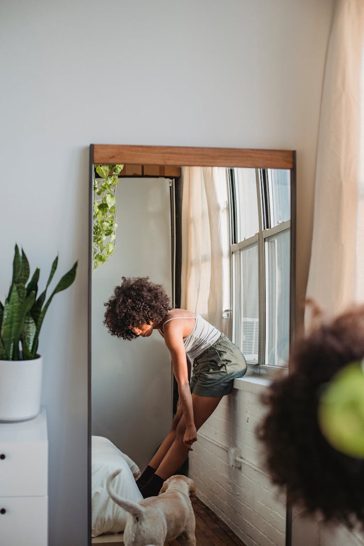 Woman With Dog Reflected In Mirror